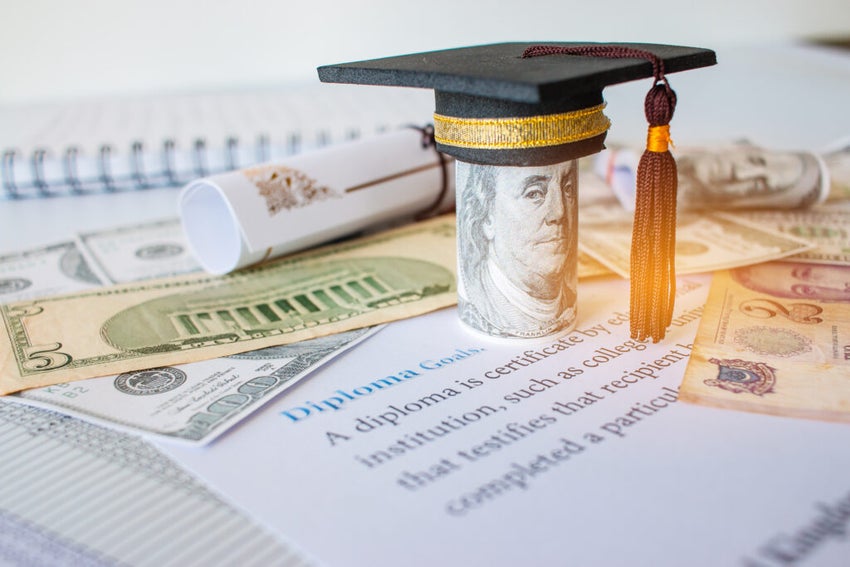 Concept,Of,Graduation,Black,Cap,On,Roll,Up,Dollars,Bill,