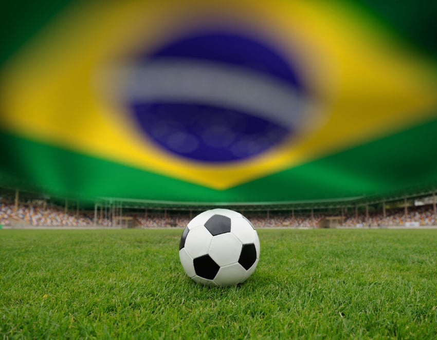Soccer,Ball,On,The,Field,Of,Stadium,On,Brazil,Flag