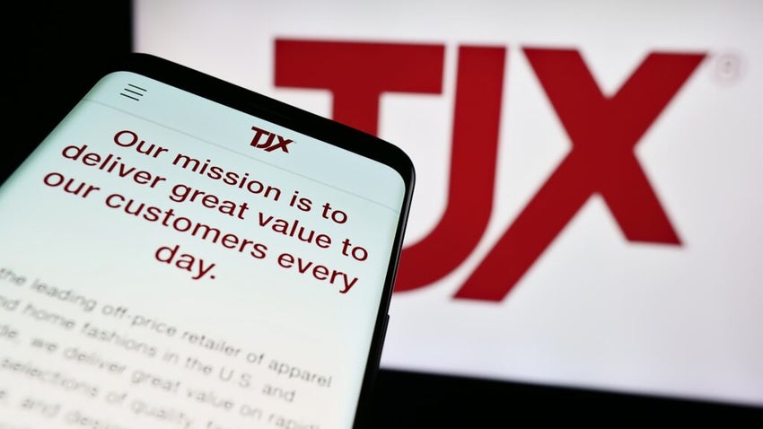 Smartphone with website of US department store company The TJX Companies Inc. in front of business logo.
