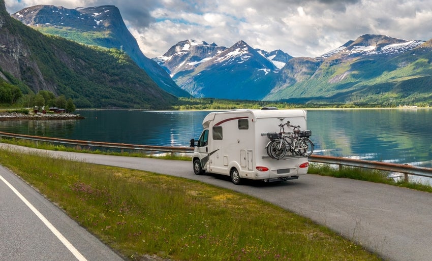 RV traveling in the mountains near a lake