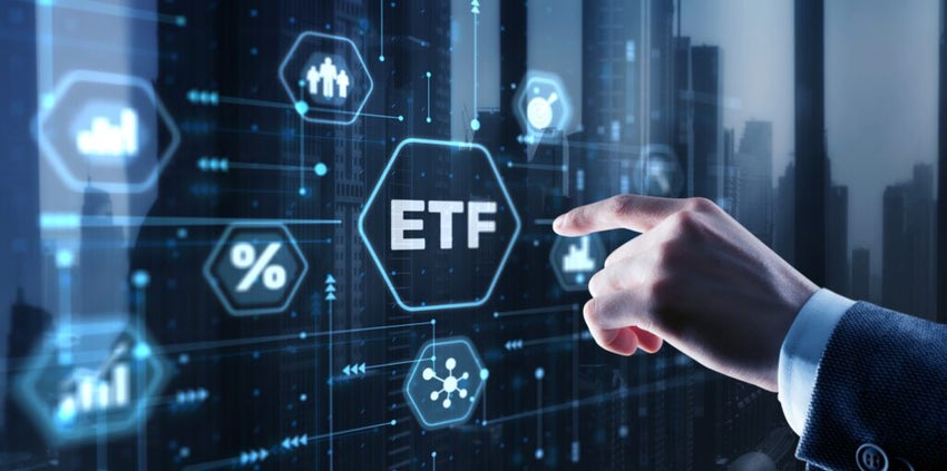 Hand pointing at digital ETF icon with financial symbols.