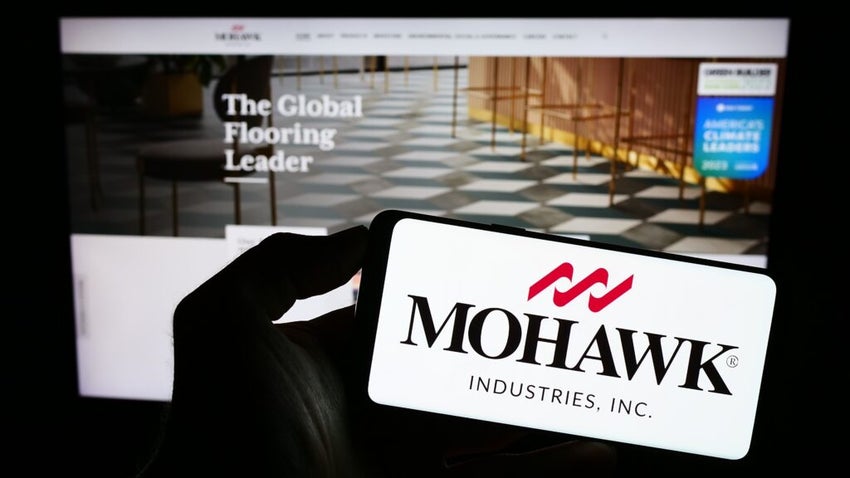 Mohawk Industries logo on iPhone against a computer screen