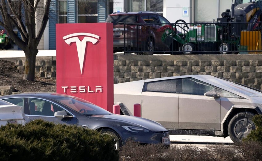 Logo of Tesla with a Cybertruck in the background