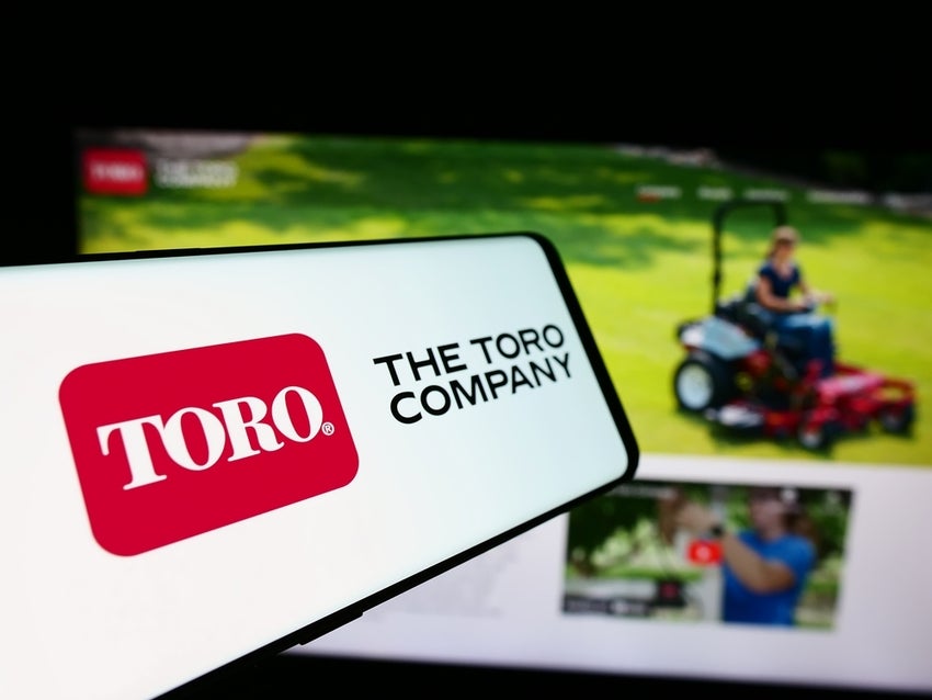 Logo of American lawn mower business The Toro Company in front of business website.
