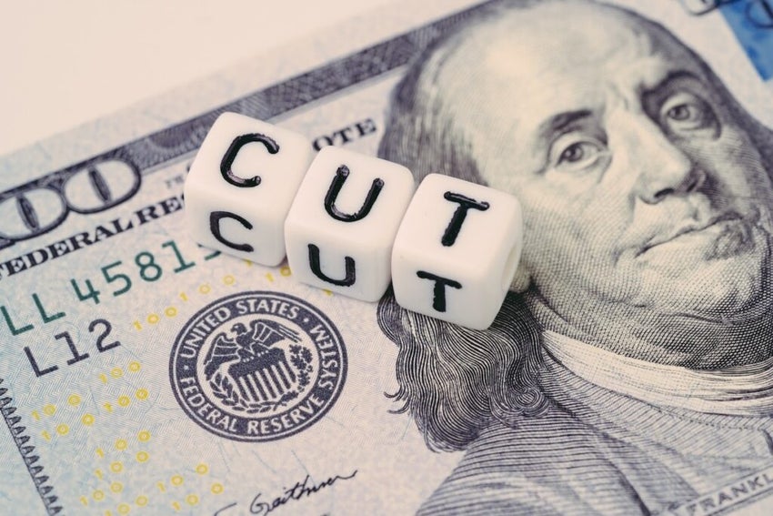 A hundred dollar note with cut dice on top