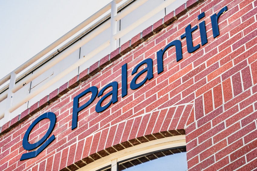 Palantir logog on a building with a red brick facade.
