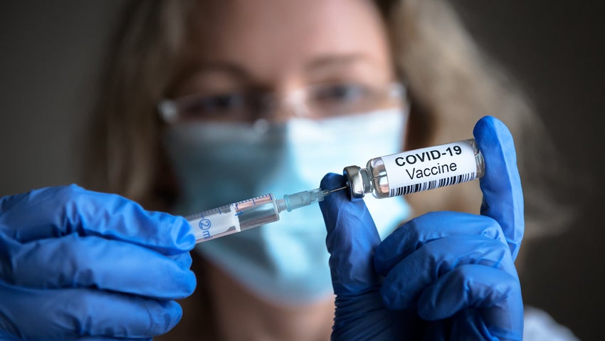 Health worker holding Covid 19 vaccine