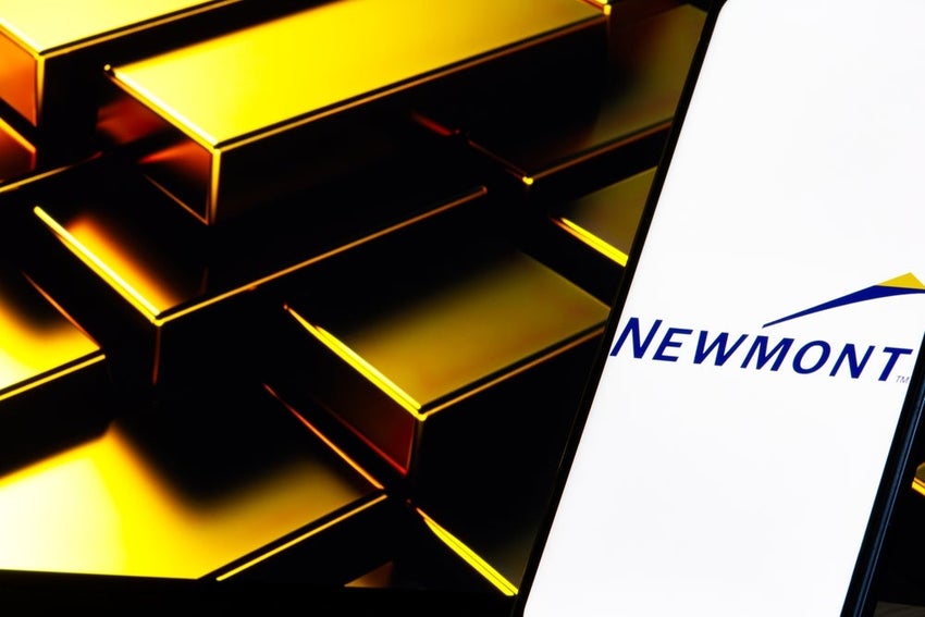 Stacked gold bars with Newmont logo on phone screen