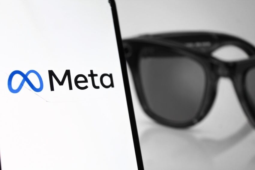Meta logo on a smartphone screen with a photo of ray ban meta ai glasses on ray ban website