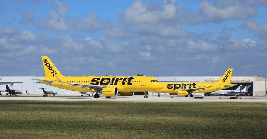 Two Spirit Airlines jets taxiing to take off.