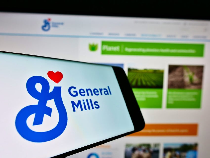 Mobile phone with logo of US food processing company General Mills Inc. on screen in front of website.