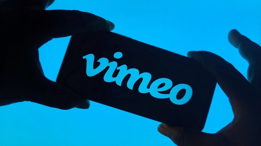 Vimeo logo on a phone being held by a person