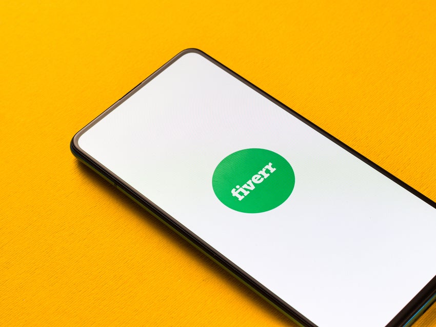 Smartphone displaying Fiverr logo on yellow background