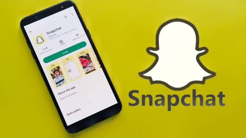 Snapchat app listing on a phone with logo in the background