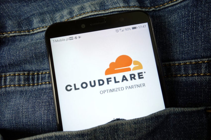 Smartphone displaying Cloudflare logo in denim pocket.