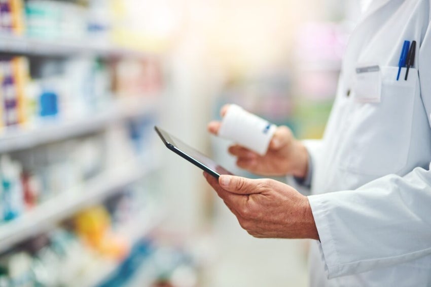 In a Pharmacy with pharmacist holding Pills And Tablet