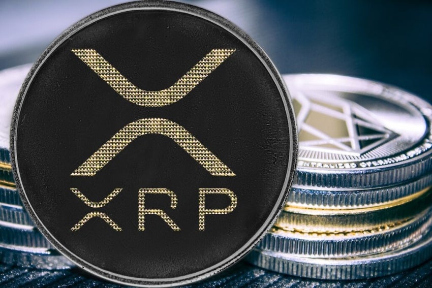 Coin cryptocurrency ripple on the background of a stack of coins