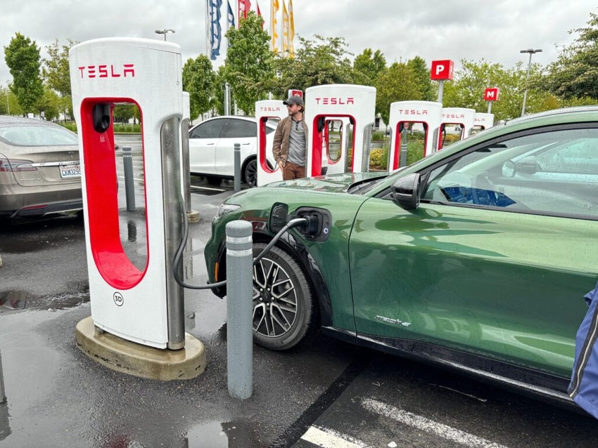Image Of Tesla Chargers with a car parked near station