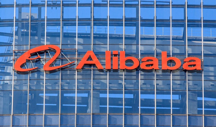 Alibaba logo on tall glass building in Beijing.