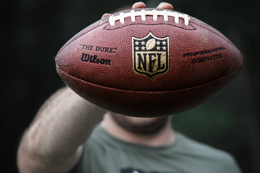 Man holding an NFL branded football