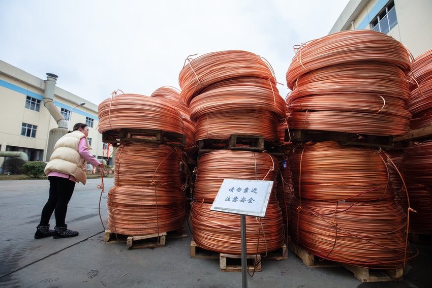 Coils of copper wire on pallets outdoors