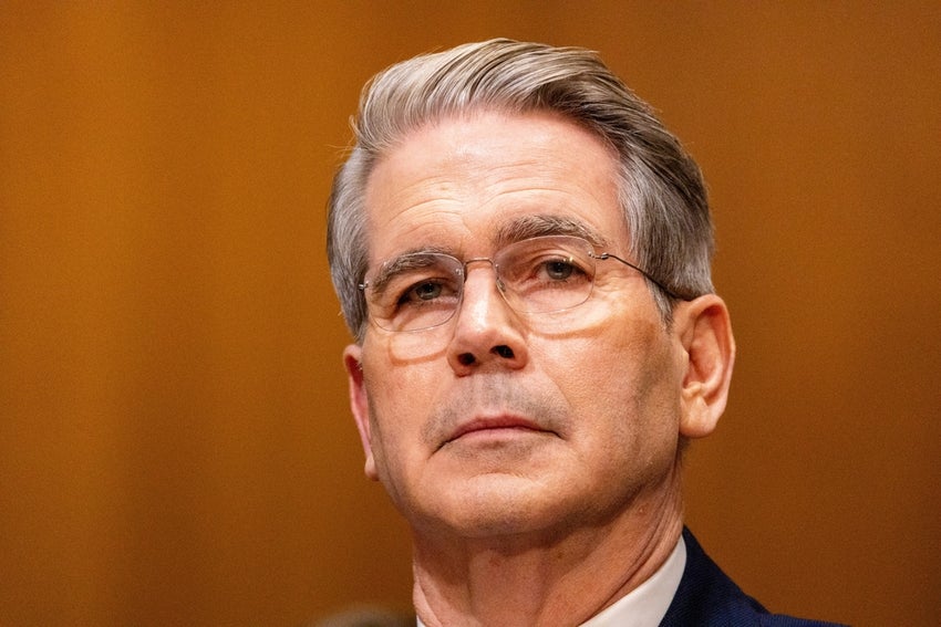Scott Bessent with glasses wearing a suit.