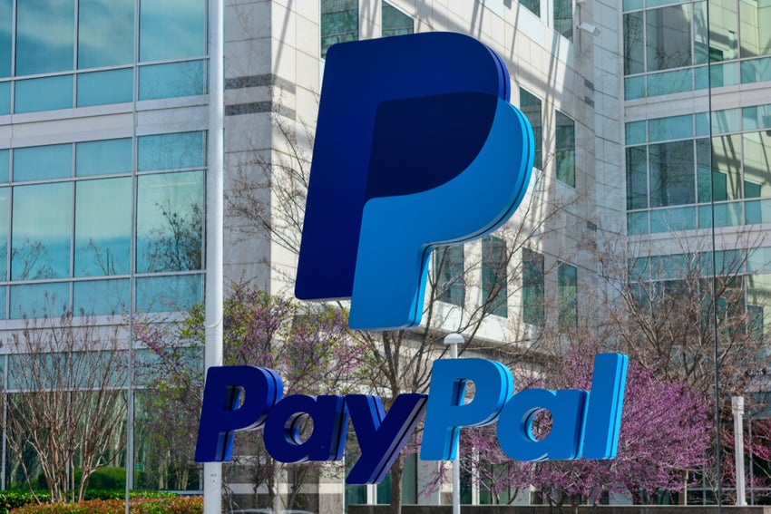 PayPal logo in front of glass building.