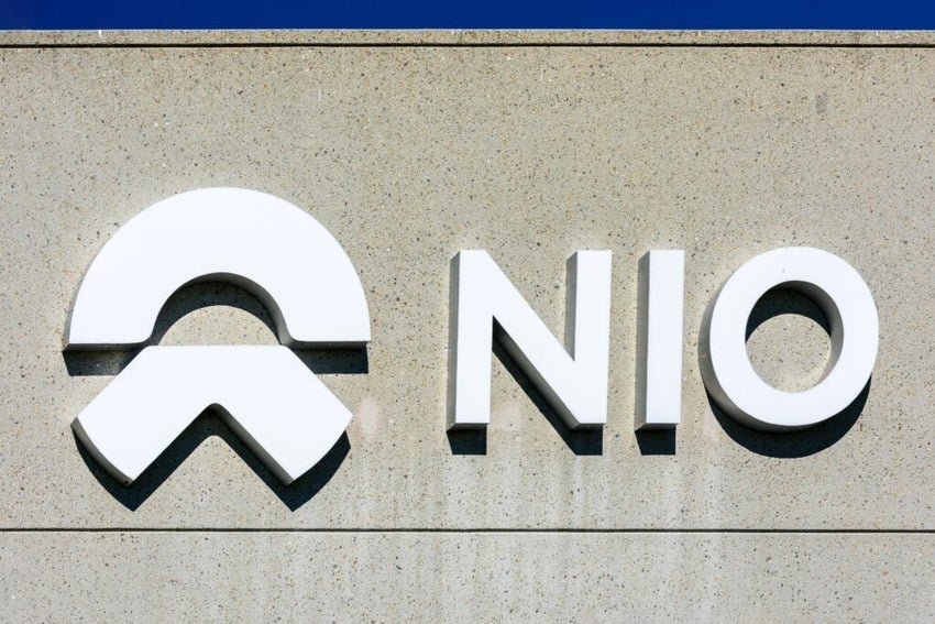 NIO logo on concrete building facade.