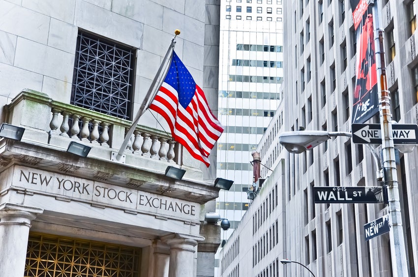 New York Stock Exchange side entrance and street sign of Wall Street.