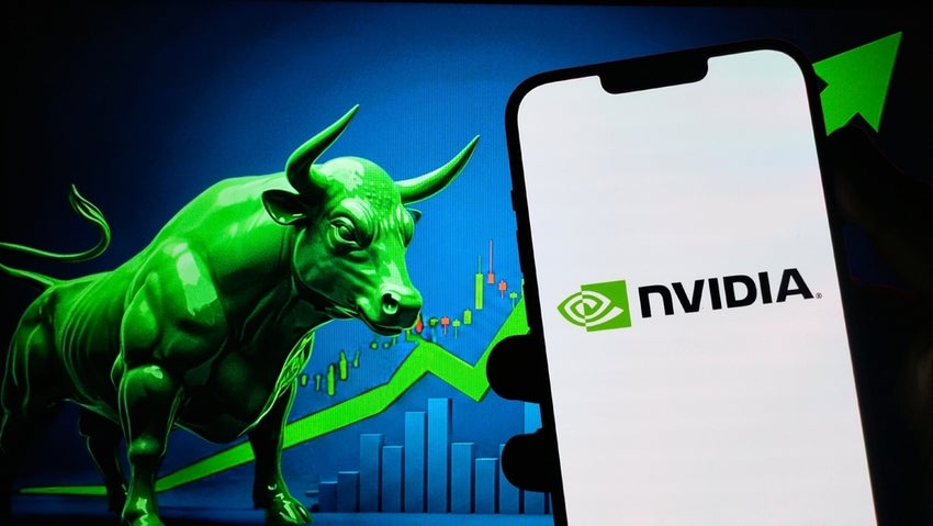 Selective focus on smartphone screen in hand displaying NVIDIA Corp NVDA logo against the background of Bullish Market Green Bull.