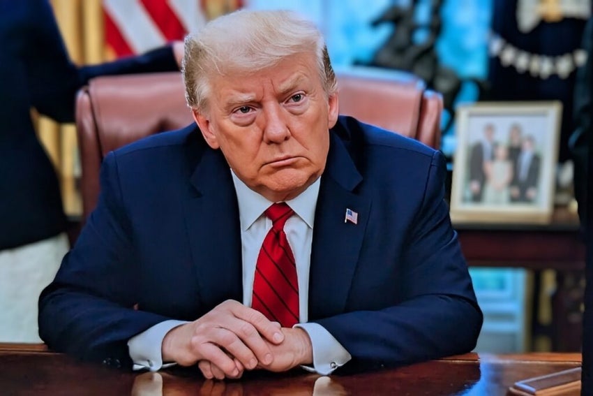 President Trump sitting at the Oval office desk.