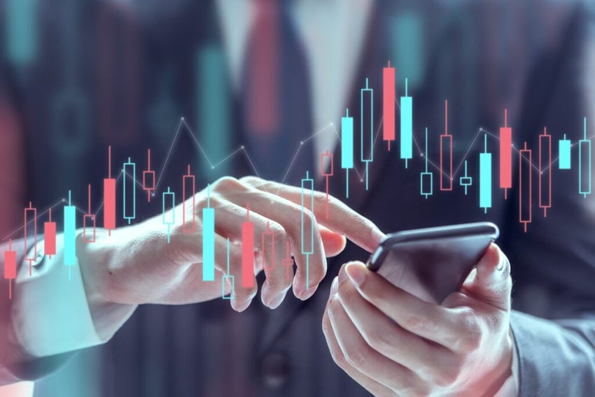 Businessman using a mobile phone to check stock market data