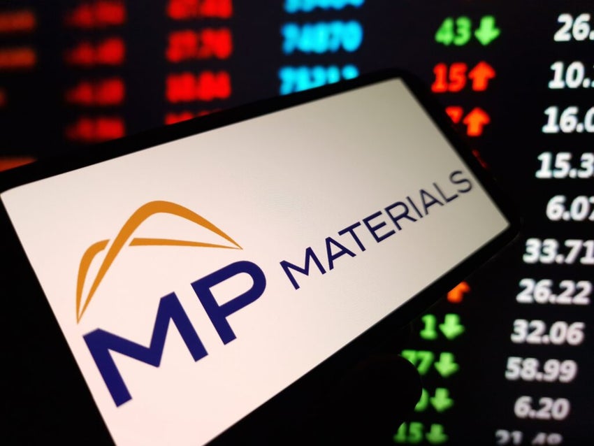 MP Materials log on a smartphone screen against a financial chart
