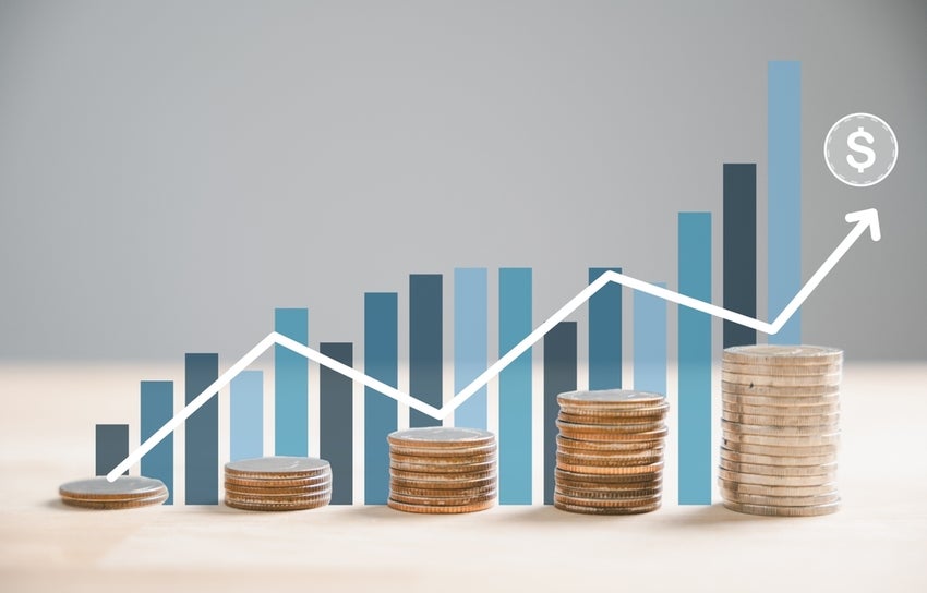 Stack of silver coins aligns with an ascending trading chart arrow.