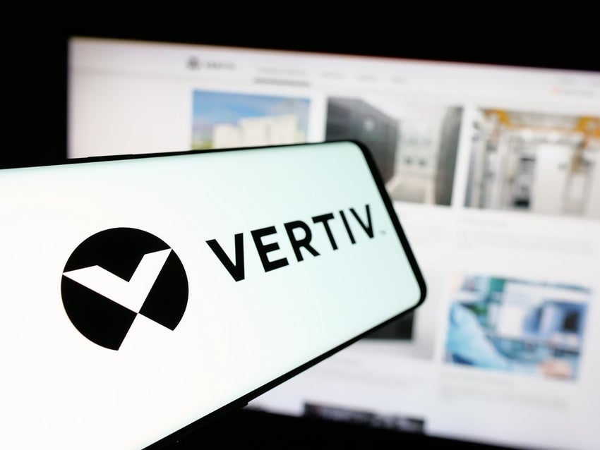 Mobile phone with logo of American technology company Vertiv Holdings Co. on screen in front of business website.