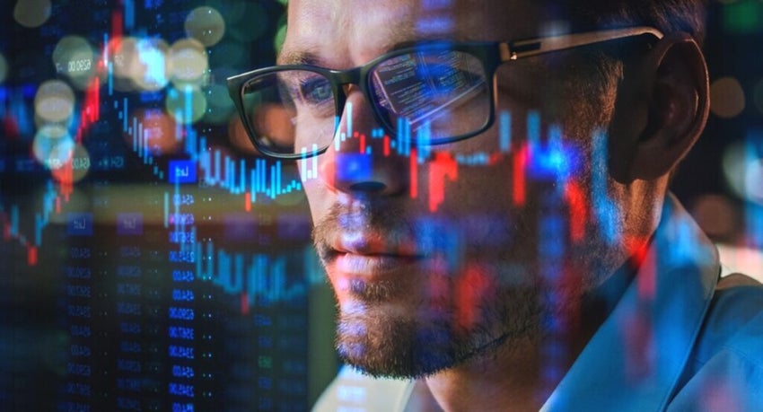 Person analyzing digital stock market graphs on screen.