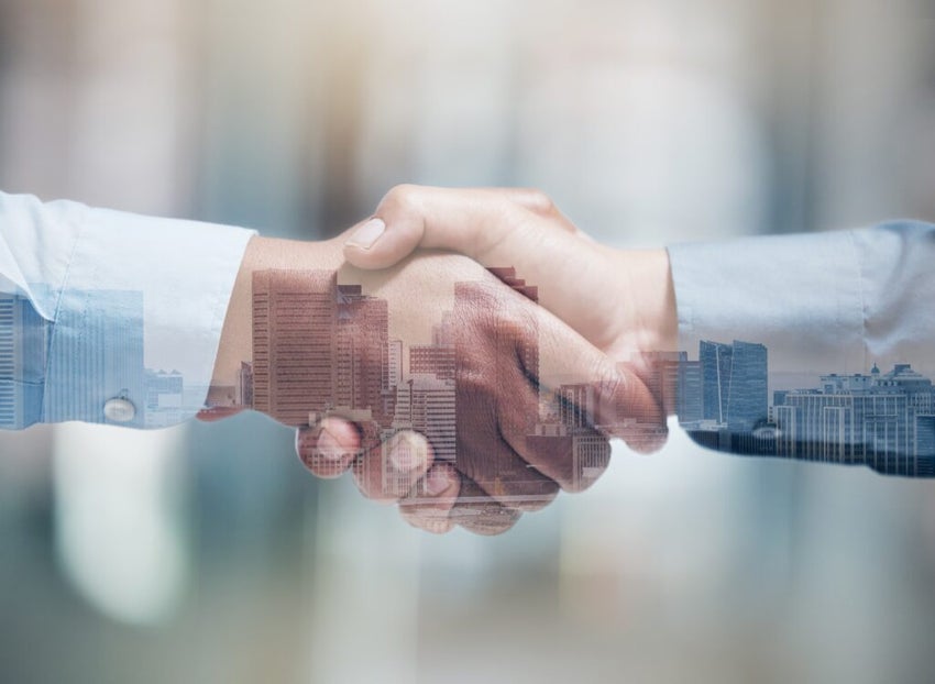 a handshake underscoring business opportunity and merger