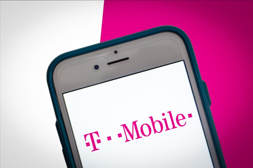 T-Mobile logo on smartphone screen pink and white background.