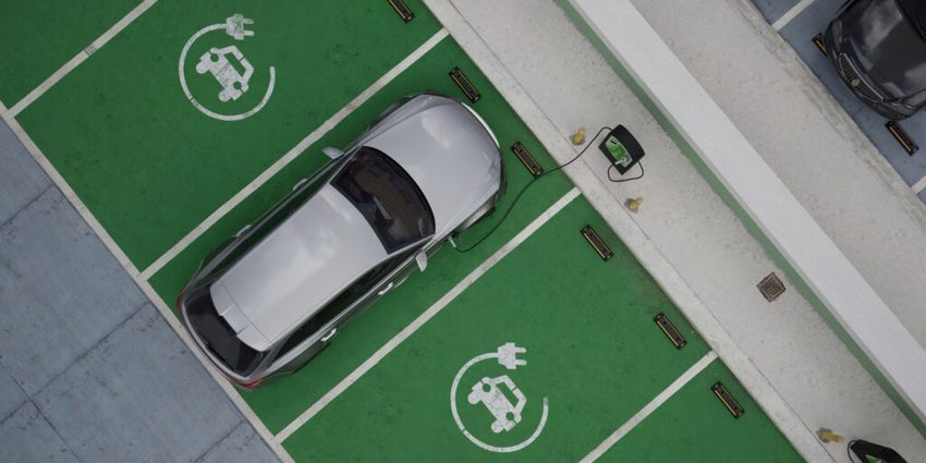Wide shot of generic EV hybrid vehicle is charging on a station, shopping mall parking