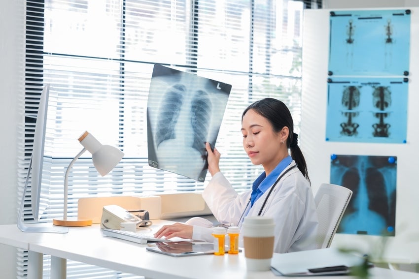 Researcher analyzing a lung X-ray scan in a medical clinic