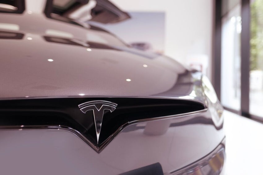 silver Tesla Model X electric car, Closeup chromium-plated Logo Tesla Motors on silver hood, Elon Musk, American company, electric vehicle production, Frankfurt, Germany - June 28, 2024