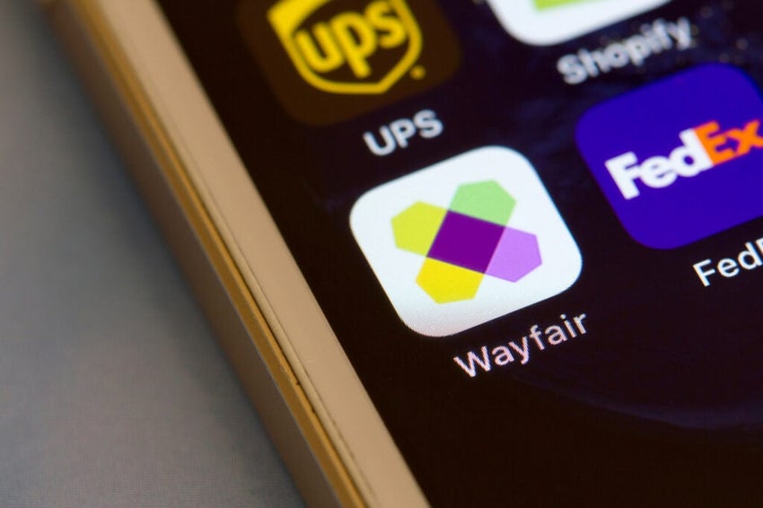 Wayfair mobile app icon is seen on a smartphone.