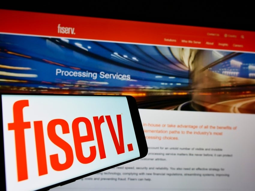 Logo of Fiserv Inc on screen in front of website