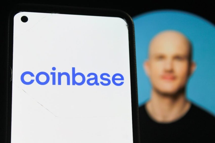 Coinbase logo displayed on a smartphone screen. With Coinbase CEO Brian Armstrong