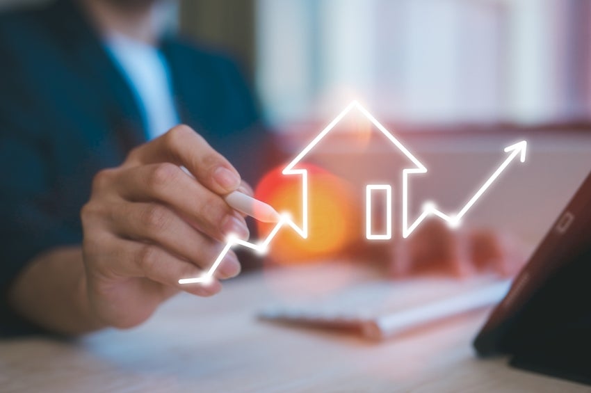 A rising stock market arrow that includes an outline of a house