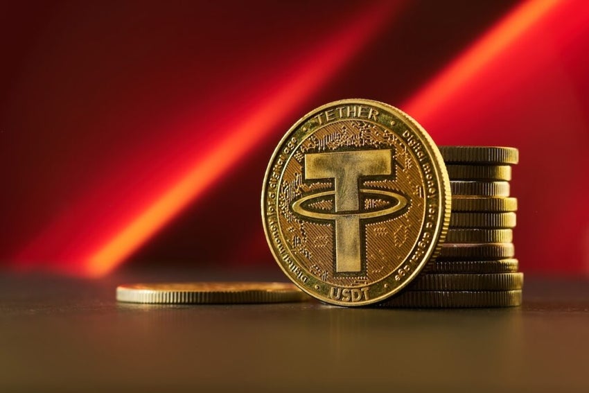 Various golden cryptocurrencies highlighting Tether coin with red textured background