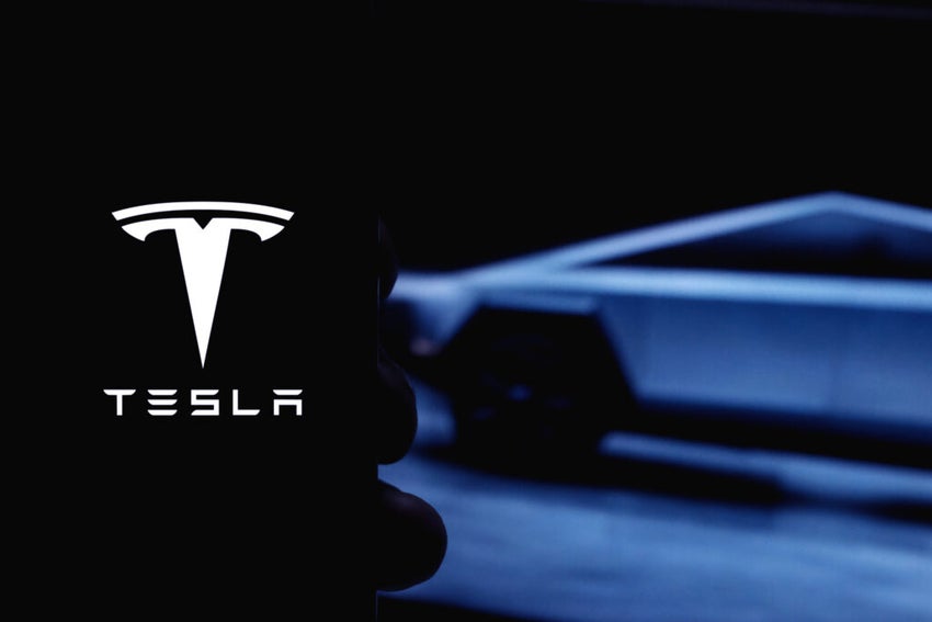 Tesla logo with a Cybertruck in the background