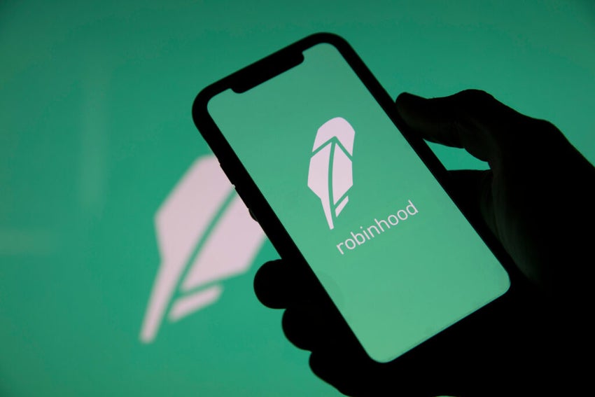 Hand holding smartphone with Robinhood logo.
