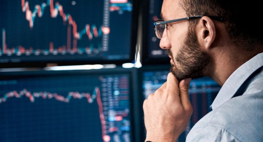 Analyst looking at a monitor with stock charts