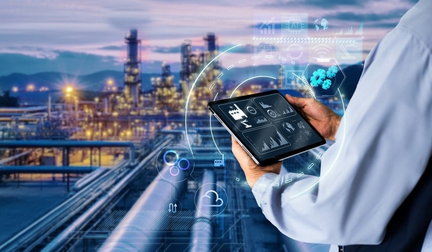 Man's hands holding tablet on blurred Chemical plant refinery industrial AI equipment as background.